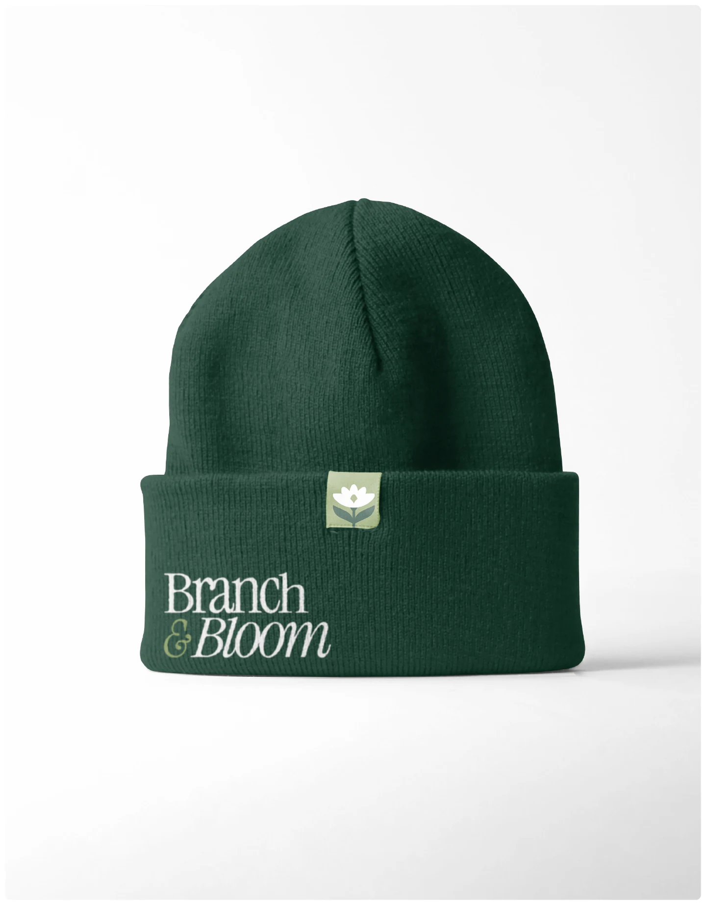 A deep-green beanie with the wordmark