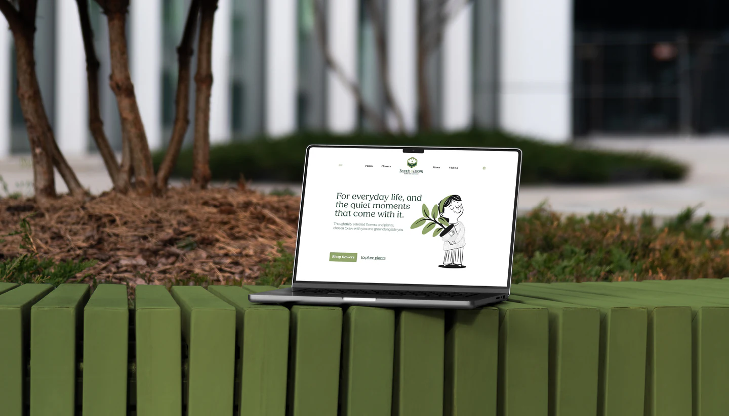 The Branch & Bloom website on a laptop outdoors