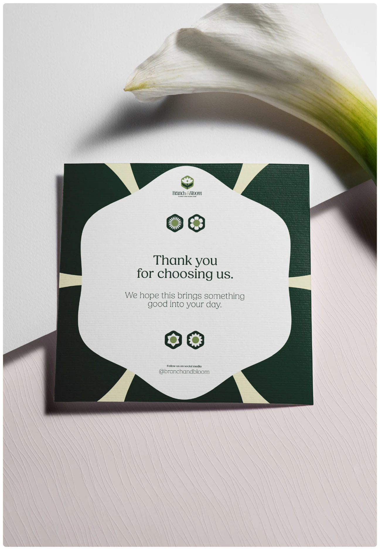 A thank-you card beside a lily