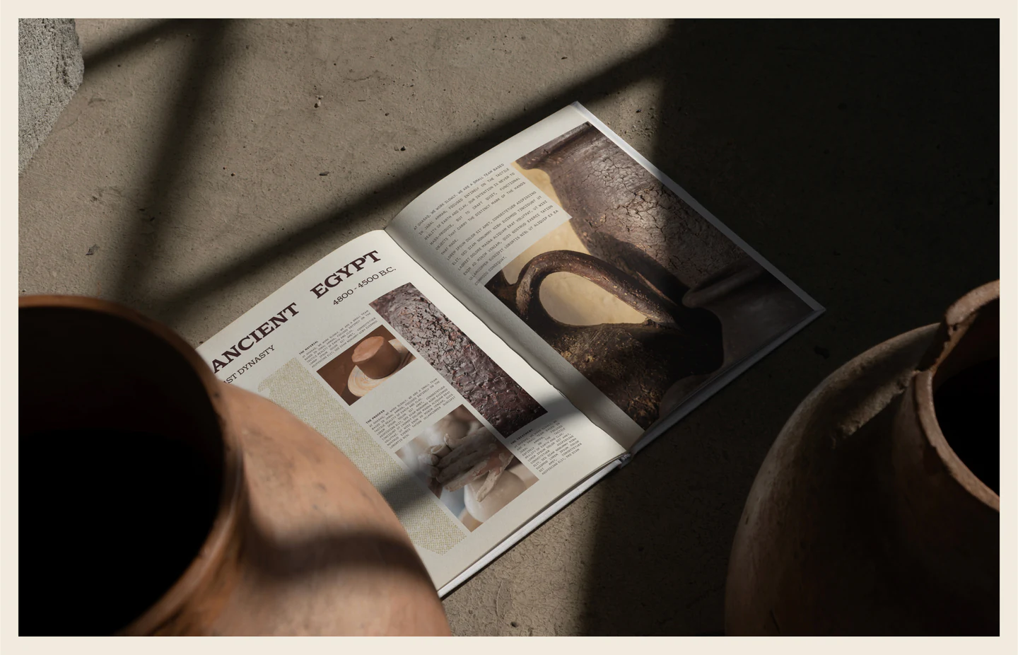An open magazine feature on ancient Egypt beside clay vessels