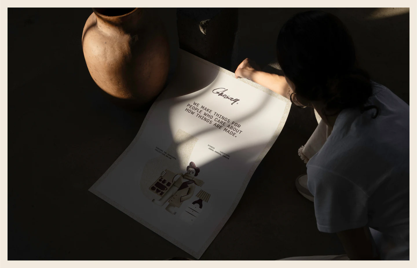 A person reading a Ghasaq sheet in low light