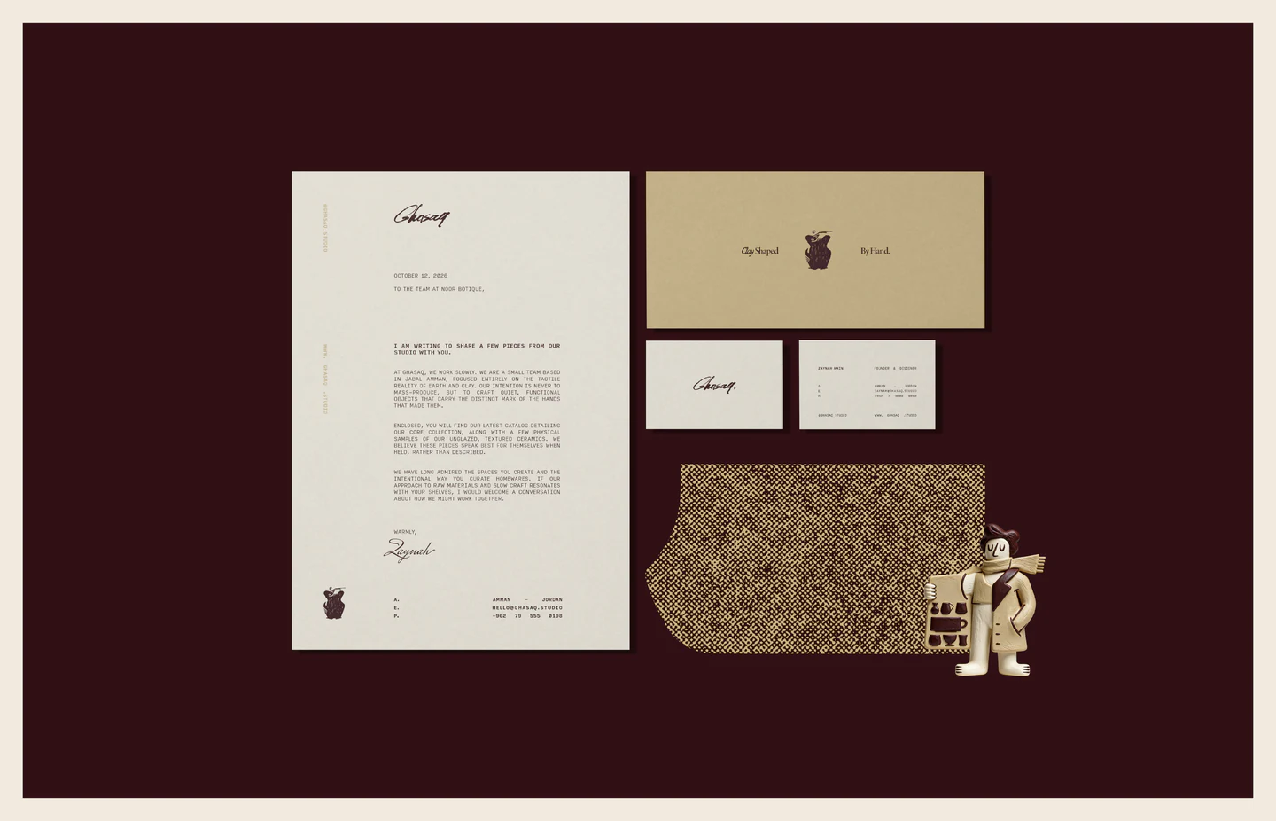 Letterhead, cards, envelopes and textured paper on maroon