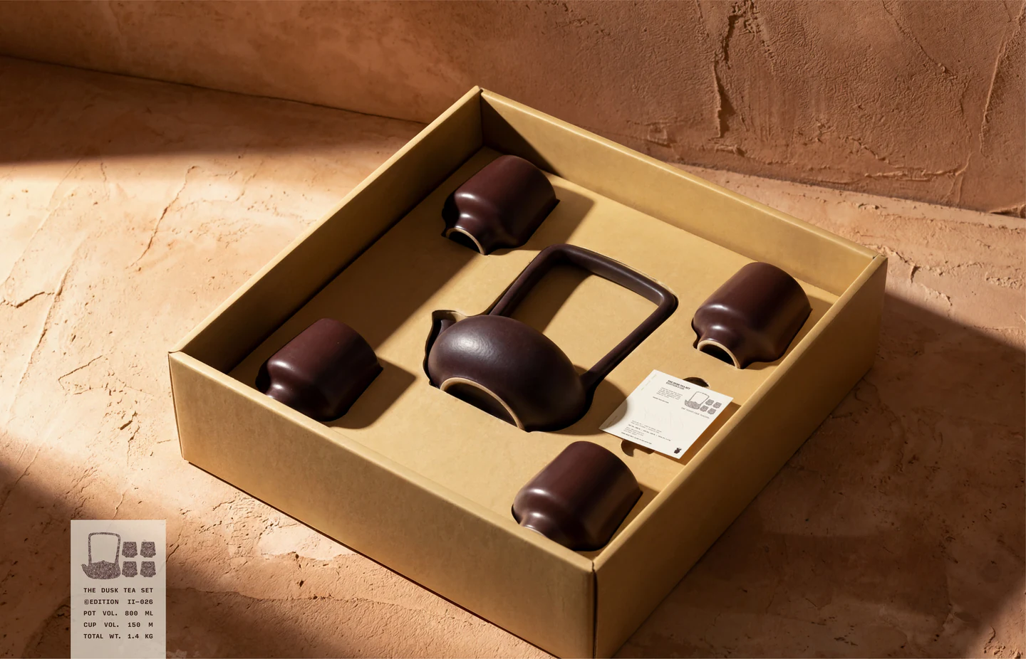 A clay tea set nested in its box